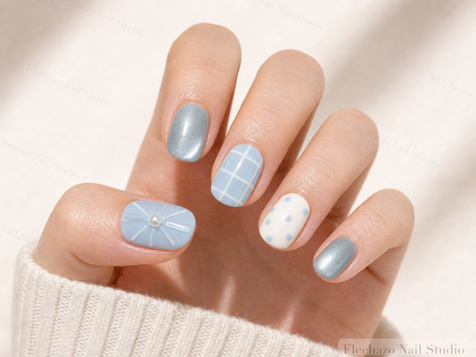Blue Teal White Gel Raised Press-On Nails worn on a model hand