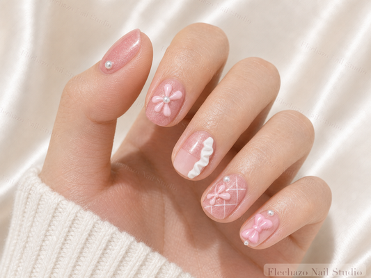 Pink Bow Ballet Ribbon Press-On Nails worn on a model hand