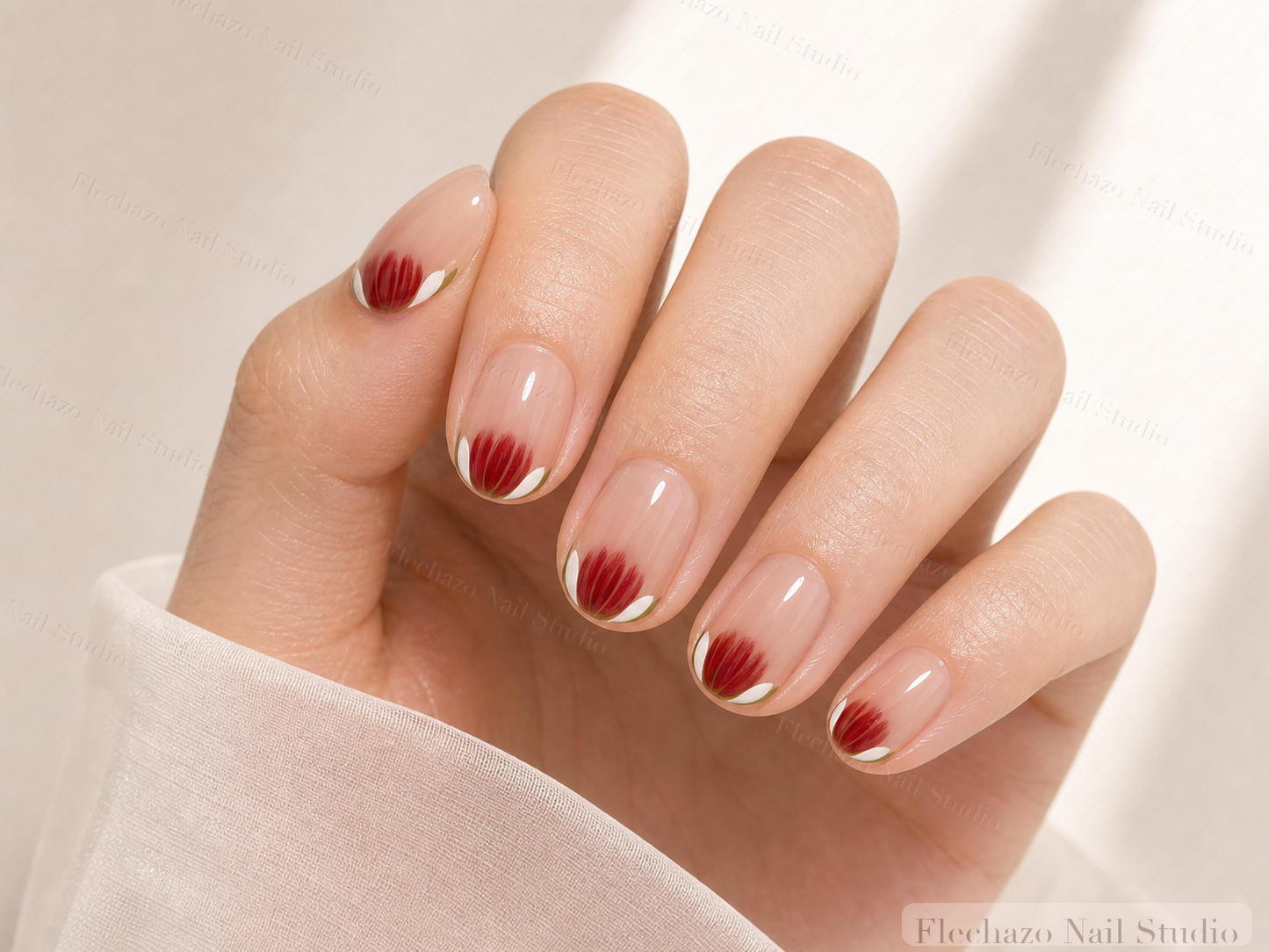Nude Red Floral Press-On Nails worn on a model hand