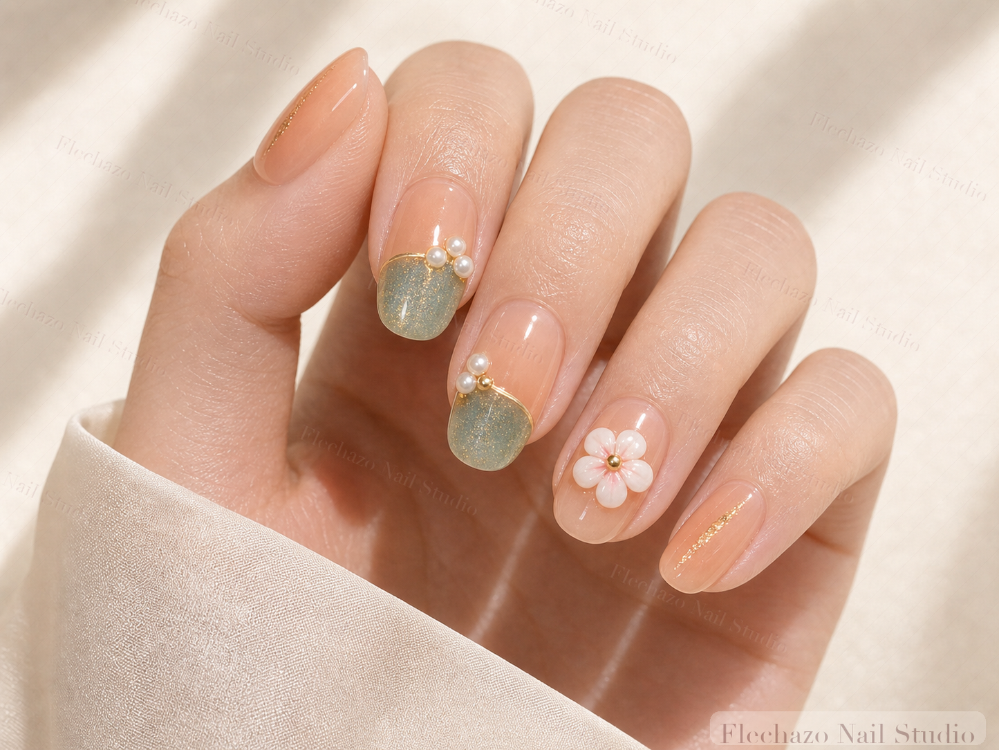 Sage Pearl Floral Press-On Nails worn on a model hand