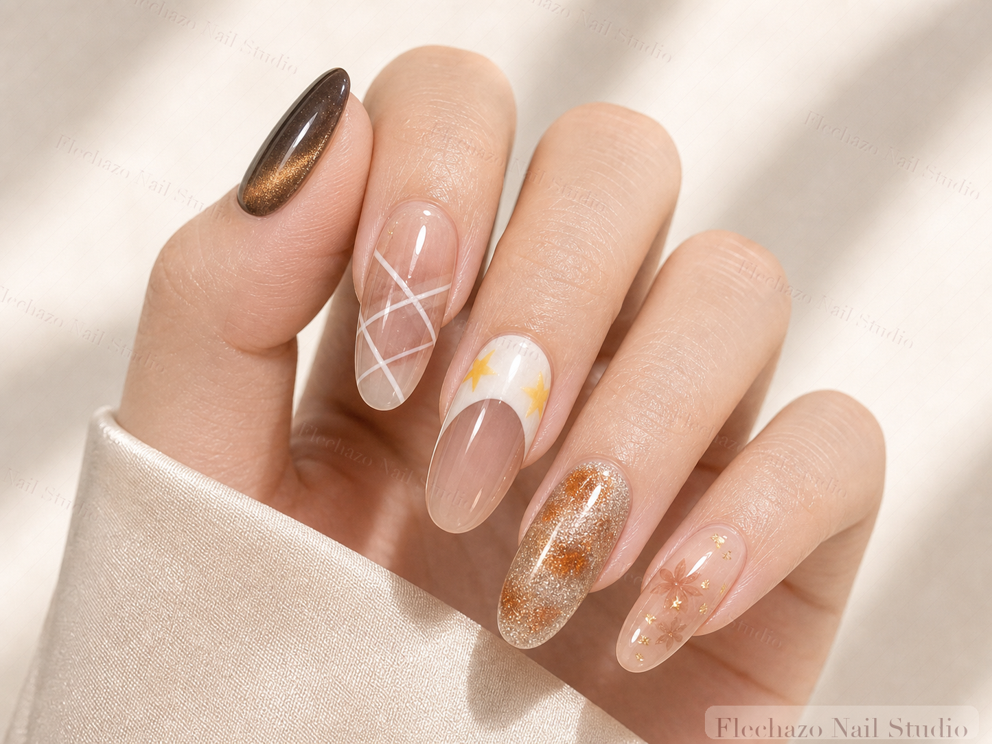 Black Gold Cat Eye Mixed Star Press-On Nails worn on a model hand