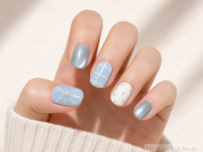 Blue Teal White Gel Raised Press-On Nails worn on a model hand
