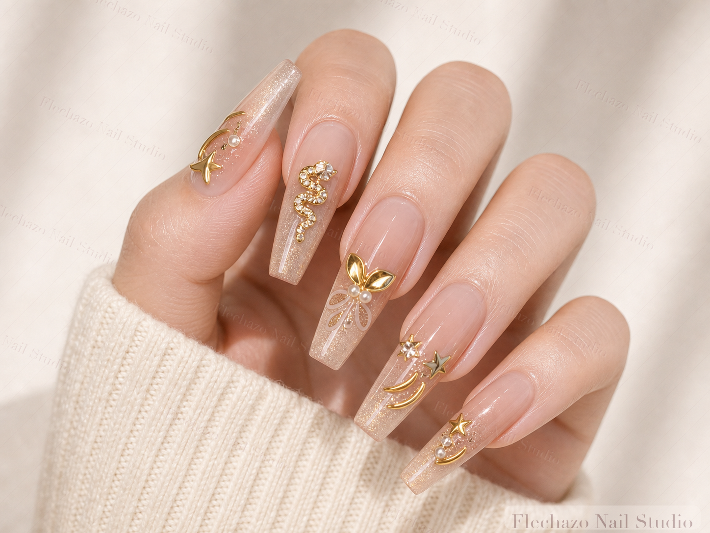 Blush Nude Gold Butterfly Charm Press-On Nails worn on a model hand