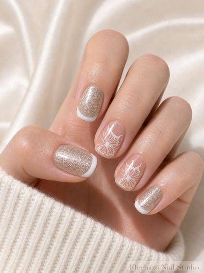 Champagne Silver Snowflake Shimmer Press-On Nails worn on a model hand