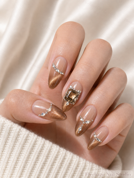 Taupe Gold Crystal Stiletto Press-On Nails worn on a model hand