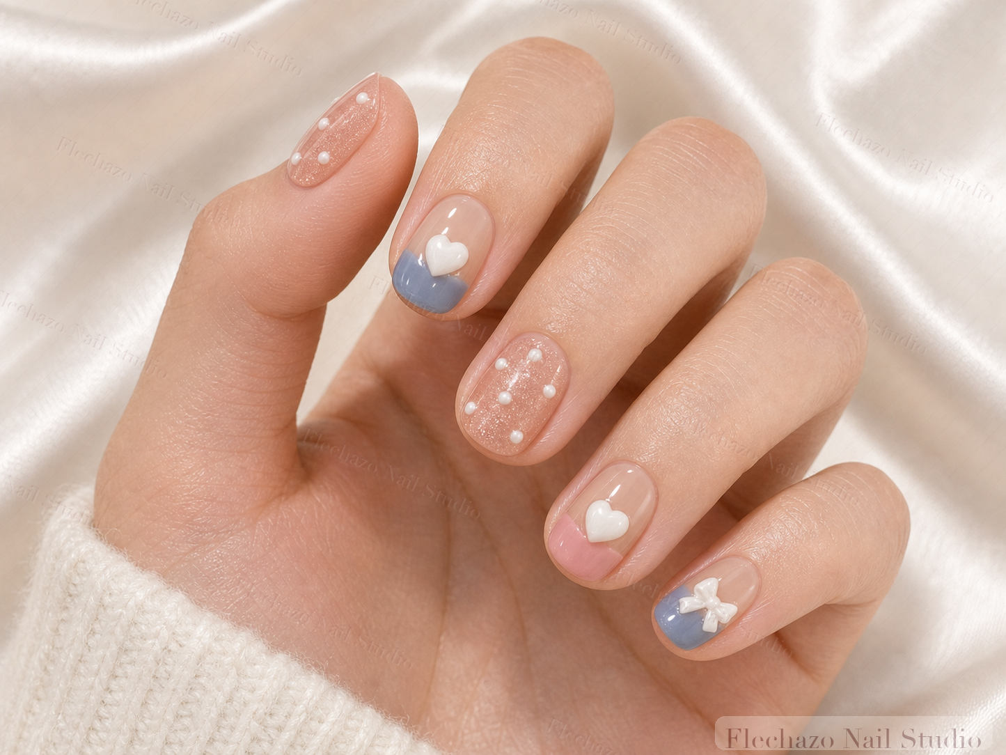 Nude Blue Pink Bunny Heart Press-On Nails worn on a model hand