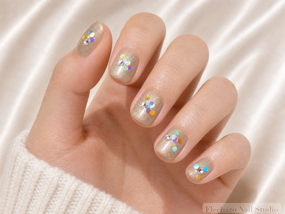 Champagne Confetti Floral Press-On Nails worn on a model hand