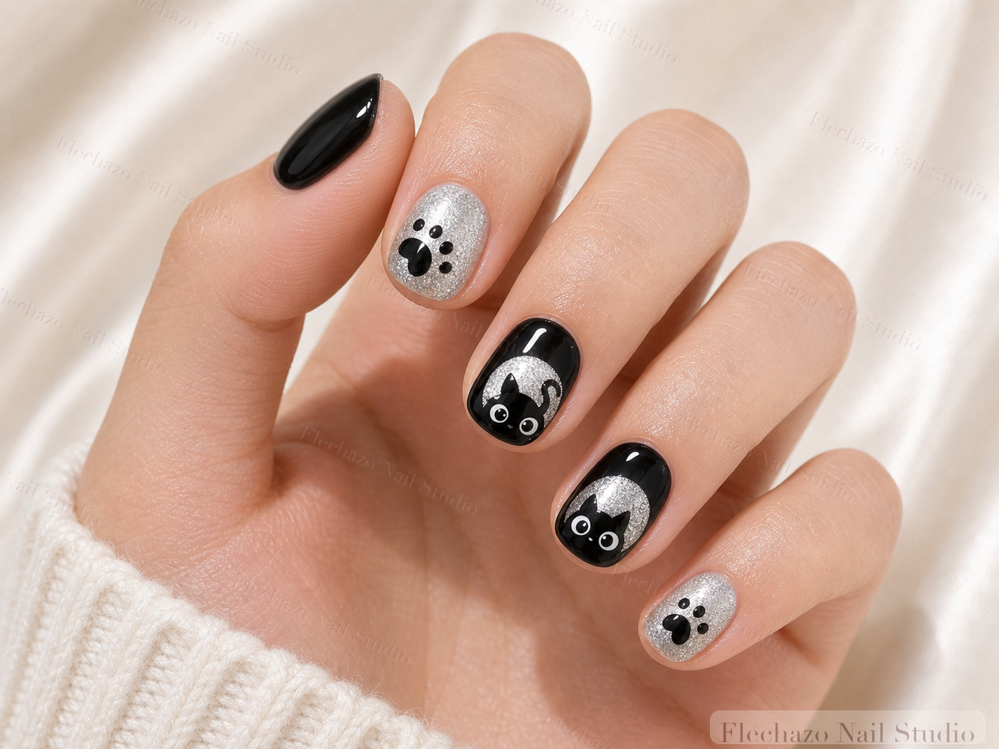 Black White Cat Moon Press-On Nails worn on a model hand