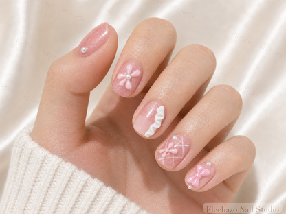 Pink Bow Ballet Ribbon Press-On Nails worn on a model hand