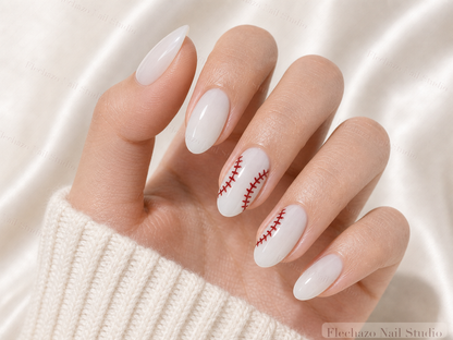 White Red Baseball Stitch Press-On Nails worn on a model hand