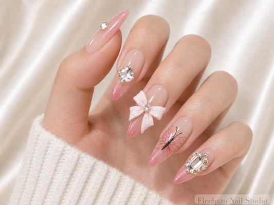 Pink Rhinestone Bow Stiletto Press-On Nails worn on a model hand