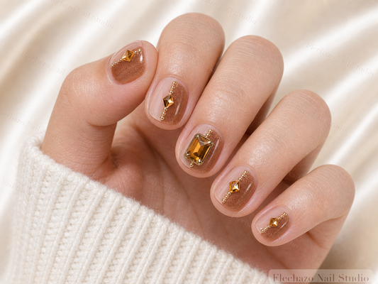 Caramel Gold Bow Jewel Press-On Nails worn on a model hand