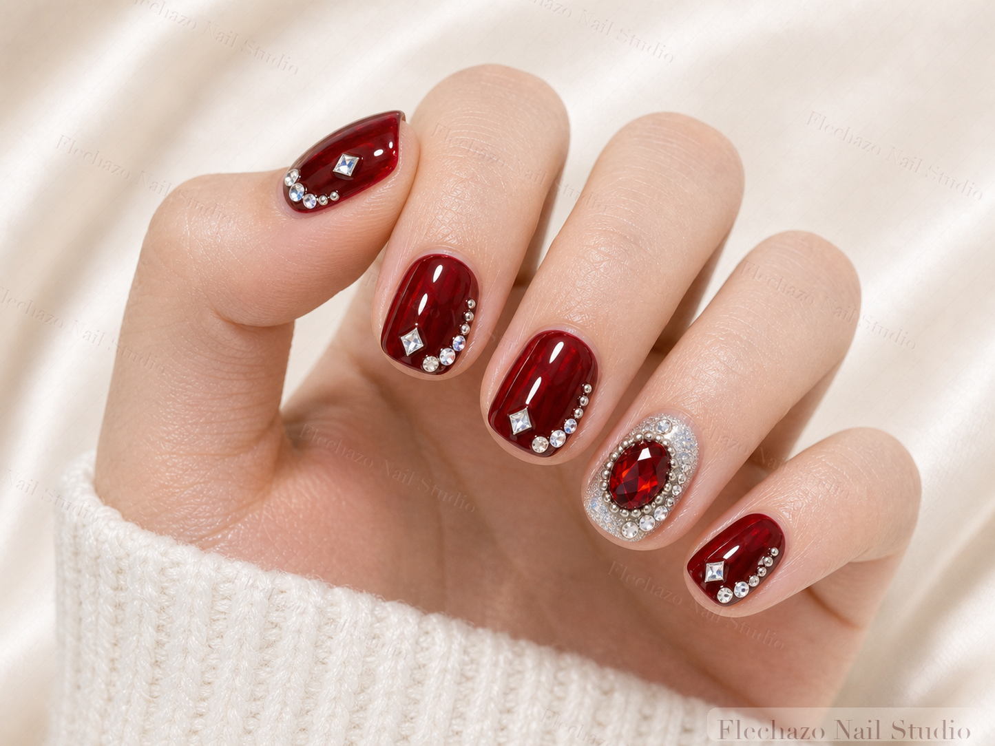 Burgundy Red Crystal Jewel Press-On Nails worn on a model hand