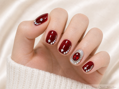 Burgundy Red Crystal Jewel Press-On Nails worn on a model hand