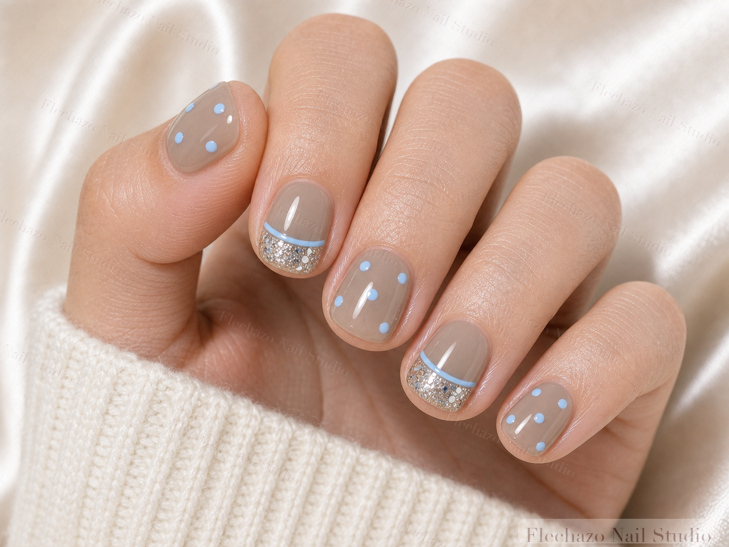 Sky Blue Polka Dots Curved Press-On Nails worn on a model hand