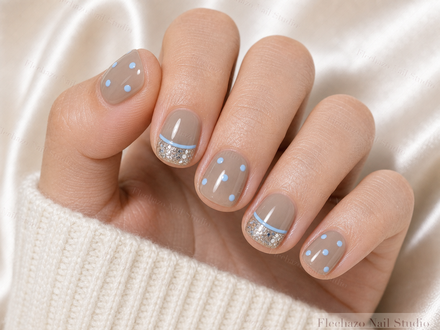 Sky Blue Polka Dots Curved Press-On Nails worn on a model hand