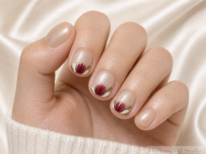 Champagne Shimmer Hand Painted Red Press-On Nails worn on a model hand
