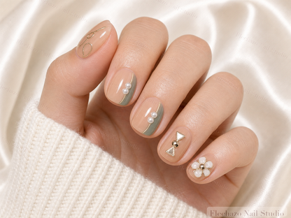 Gold Line Art Pearls Rhinestones Press-On Nails worn on a model hand