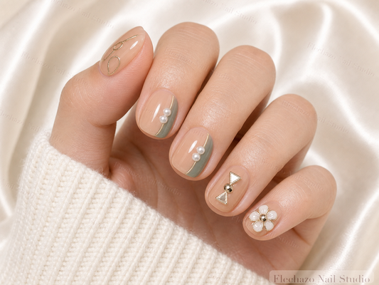 Gold Line Art Pearls Rhinestones Press-On Nails worn on a model hand